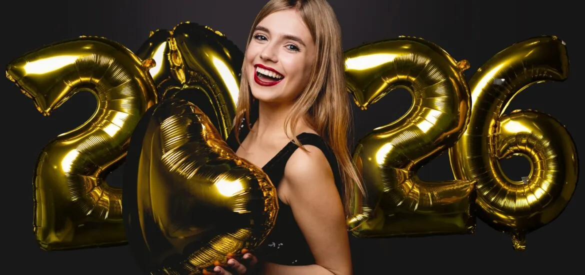 smiling young woman holding 2026 balloons, perfect white teeth