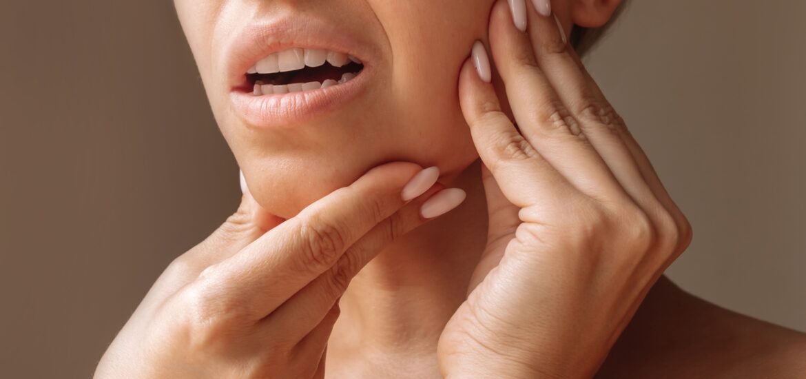 closeup cropped shot of a woman suffering from jaw pain